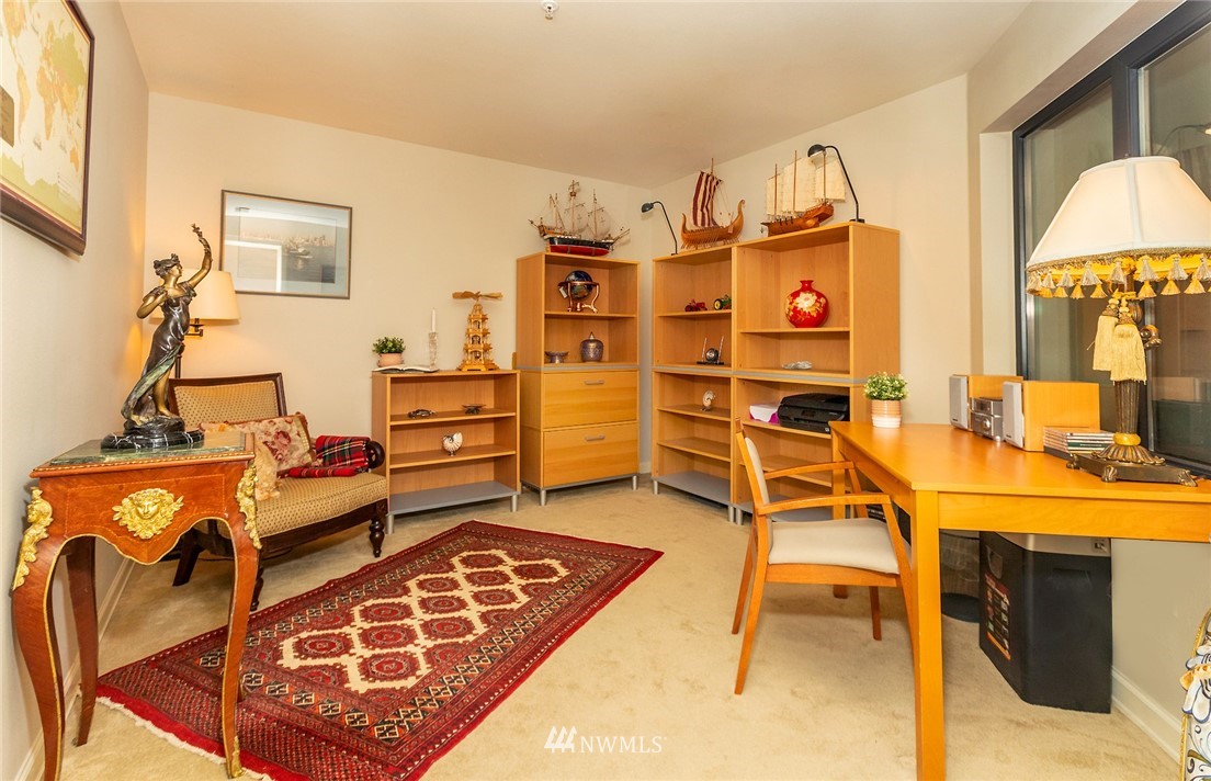 1331 Harbor Avenue Southwest, Unit 103 Seattle, WA 98116 - Photo 28 of 32 a bedroom with furniture and a wooden floor