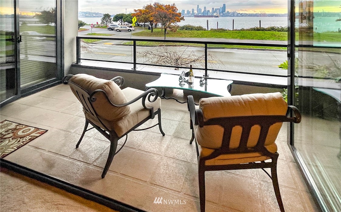 1331 Harbor Avenue Southwest, Unit 103 Seattle, WA 98116 - Photo 32 of 32 a balcony with table and chairs