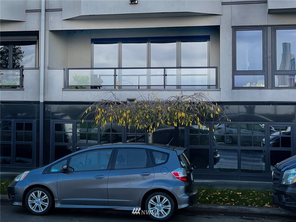 1331 Harbor Avenue Southwest, Unit 103 Seattle, WA 98116 - Photo 4 of 32 a front view of a house with parking