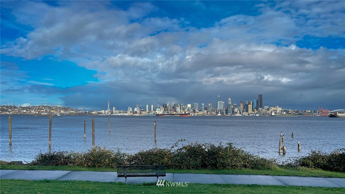 1331 Harbor Avenue Southwest, Unit 103 Seattle, WA 98116 - Photo 5 of 32 a view of a city with lots of lake and buildings in the background