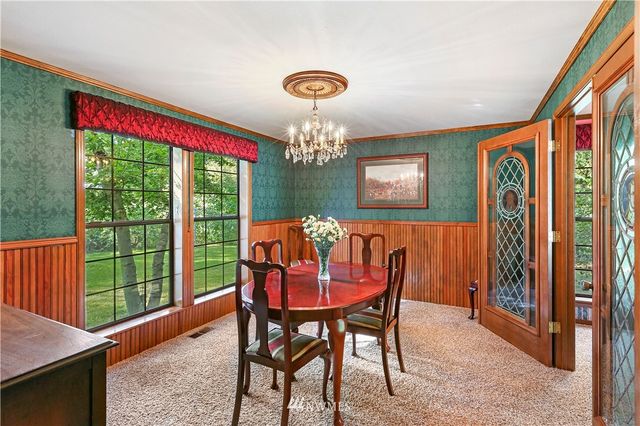 a kitchen with stainless steel appliances kitchen island granite countertop a stove and cabinets