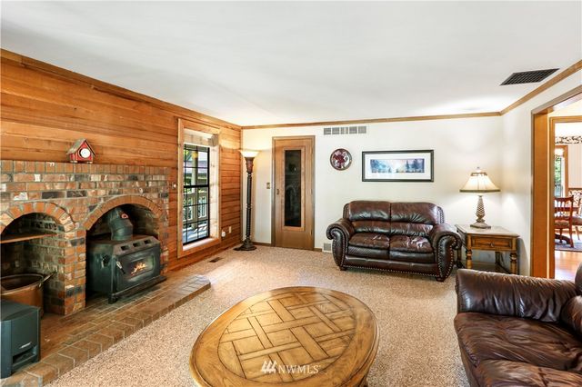 a bedroom with a bed and a dresser with mirror