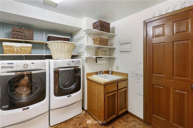 a bedroom with a bed a lamp and a window