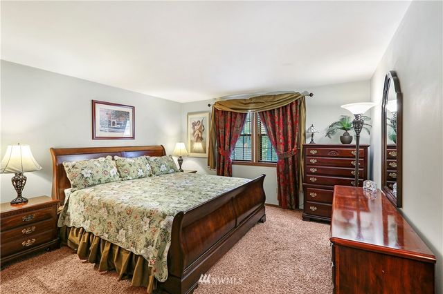 a bathroom with a granite countertop sink mirror and toilet
