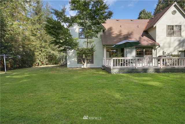 a balcony with table and chairs