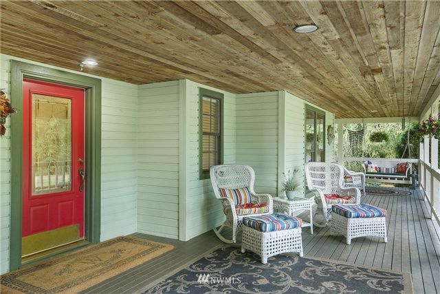 a living room with furniture a rug and a wall painting