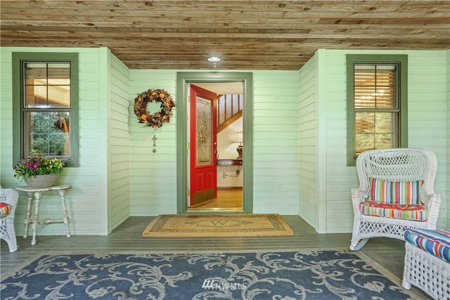 a dining room with furniture a chandelier and window