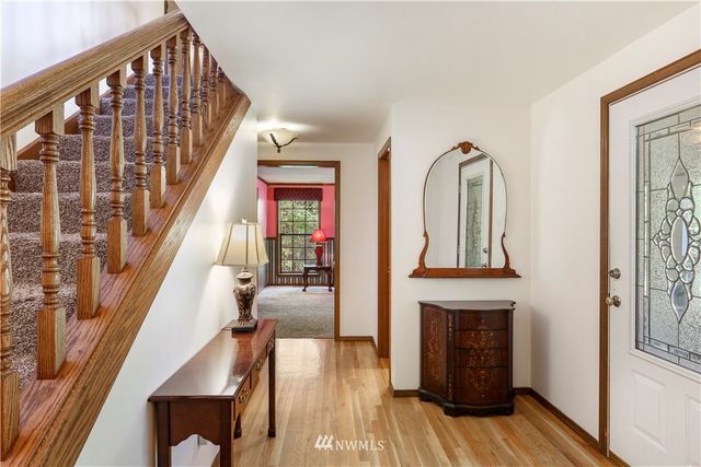 a dining room with furniture a large window and a chandelier