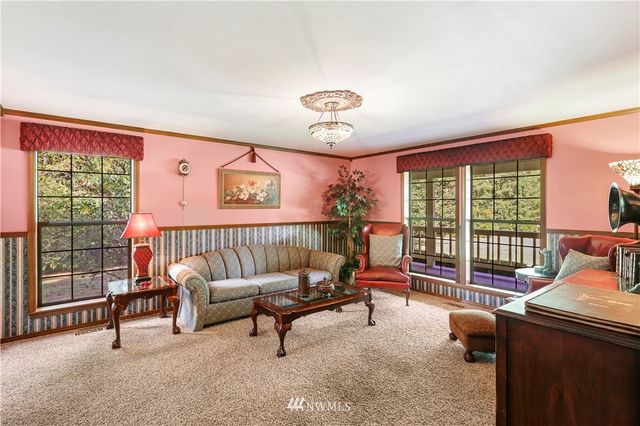 a kitchen with stainless steel appliances granite countertop wooden cabinets a sink dishwasher a stove and a refrigerator with wooden floor