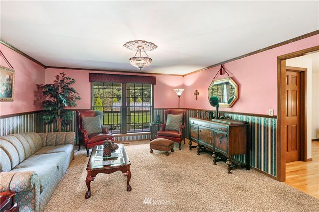 a kitchen with stainless steel appliances granite countertop wooden cabinets a sink and dishwasher with wooden floor