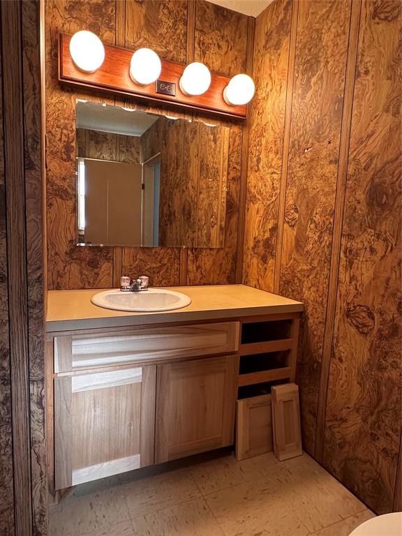 205 First Street Bangs, TX 76823 - Photo 7 of 16 a bathroom with a sink and a mirror