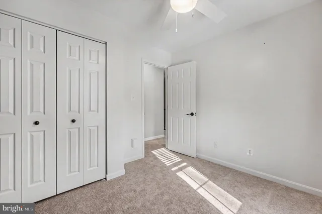 a view of a livingroom with wooden floor and a bathroom