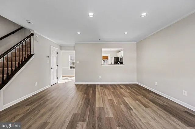 a view of a room with wooden floor and window