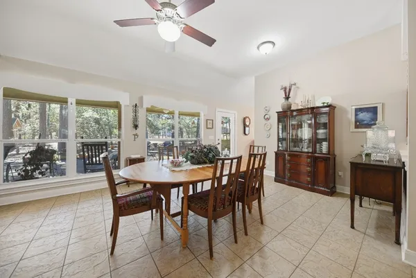 a view of a dining room with furniture and a potted plant