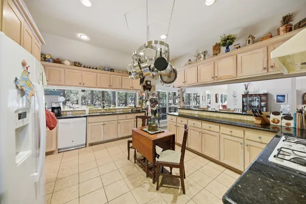 a kitchen with stainless steel appliances granite countertop a sink and cabinets