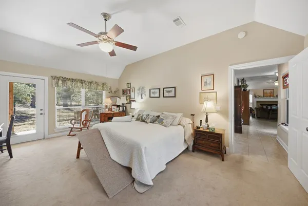a spacious bedroom with a bed and large cabinets