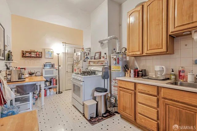 a kitchen with a stove a sink and a window