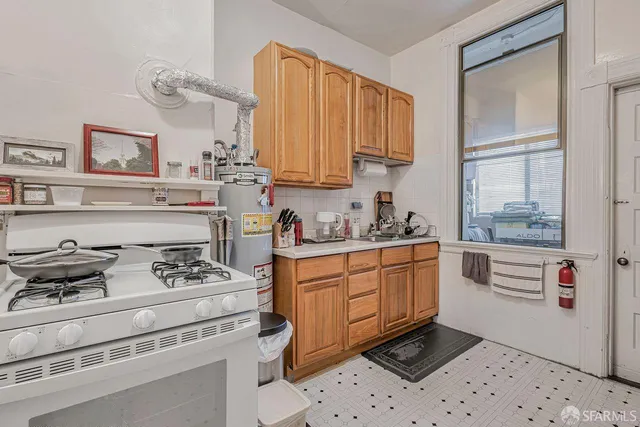 a kitchen with stainless steel appliances granite countertop a stove and cabinets