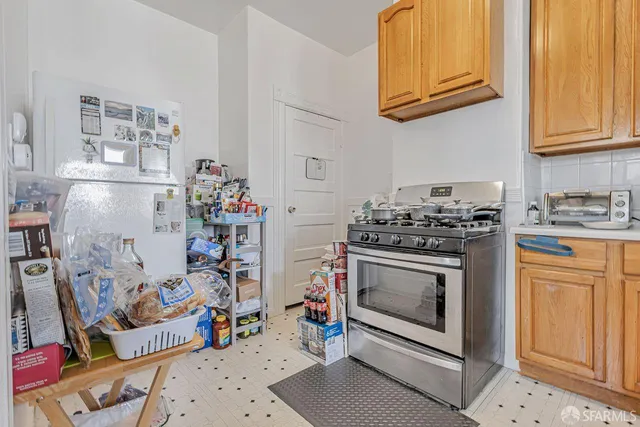 a kitchen with a stove a sink and cabinets