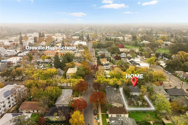 an aerial view of residential houses with city view