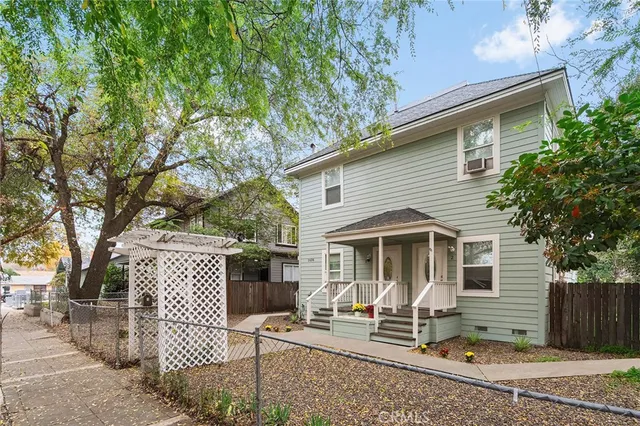 a front view of house with a garden