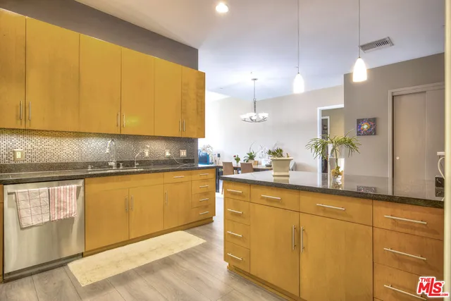 a kitchen with granite countertop sink and cabinets