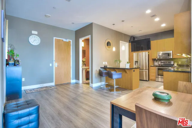 a living room with kitchen island furniture and a kitchen view