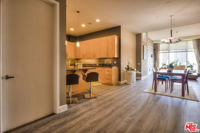 a view of a kitchen with dining room and wooden floor