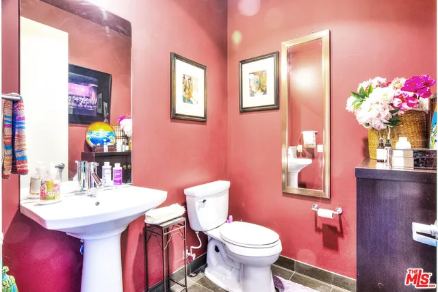 a bathroom with a sink mirror and toilet