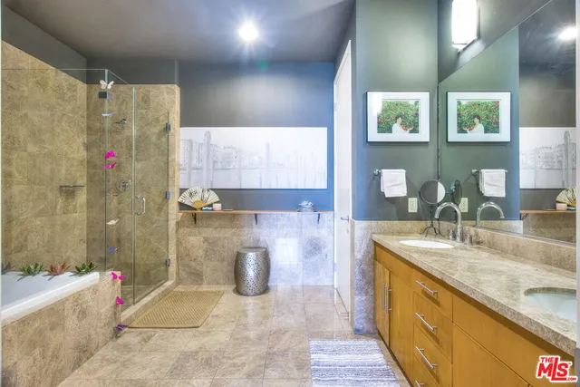 a bathroom with a granite countertop sink a toilet and shower