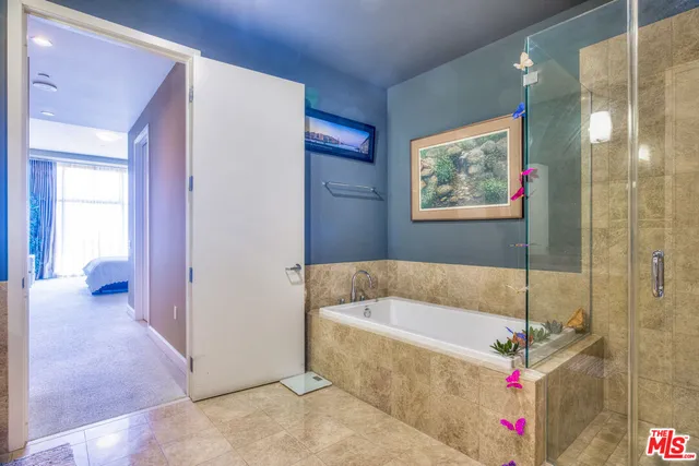 a bathroom with a bathtub and a shower