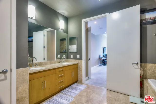 a bathroom with a double vanity sink and mirror