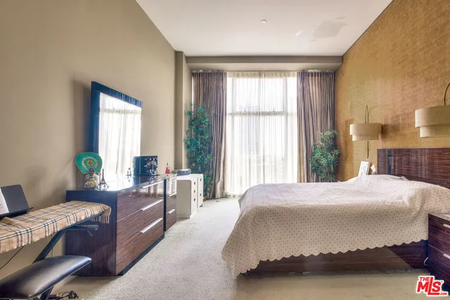 a bedroom with a bed and a couch