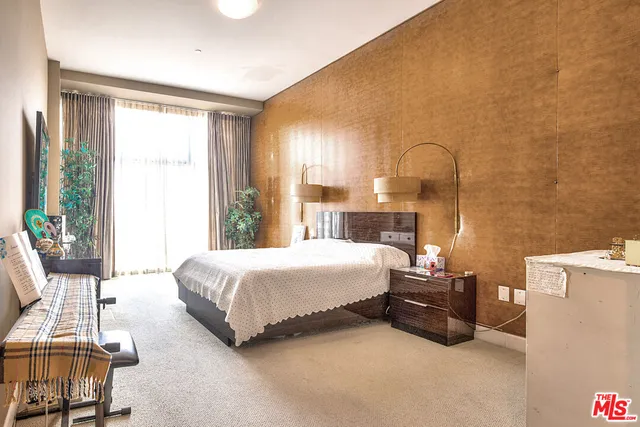 a spacious bedroom with a bed and a table