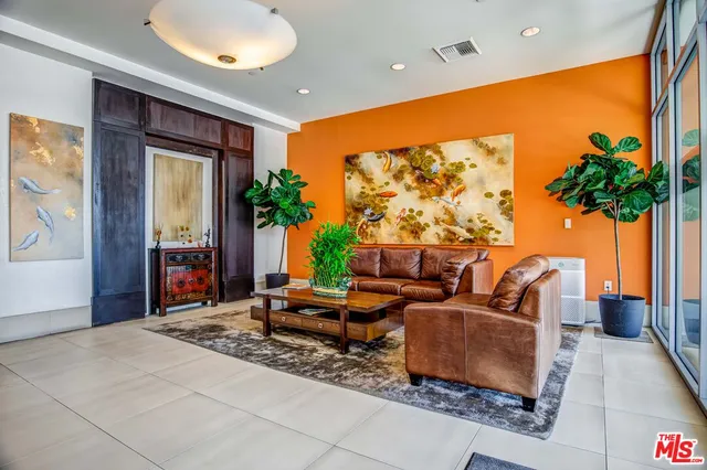 a living room with patio furniture and a potted plant