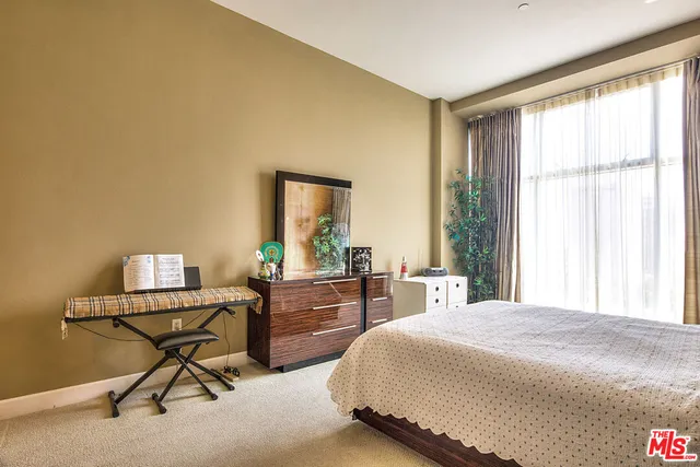 a bedroom with a bed and a desk