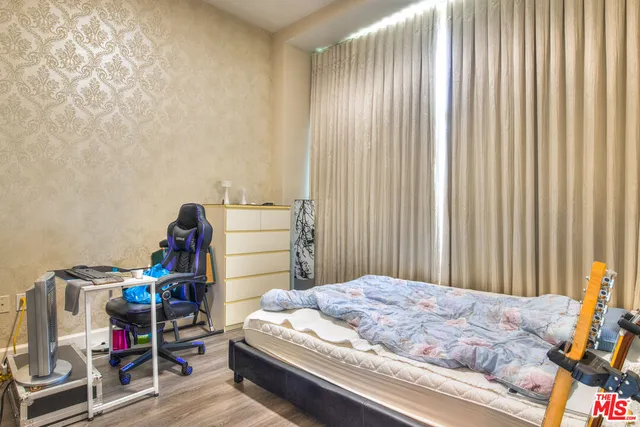 a bedroom with a bed and a book shelf