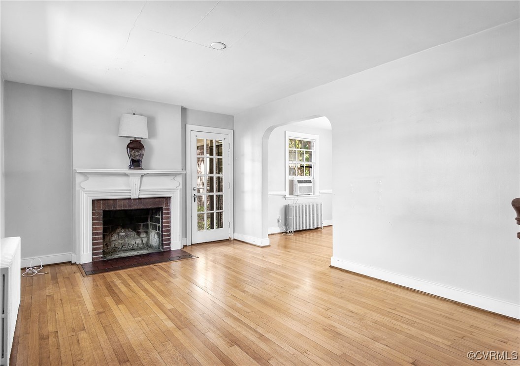 4521 Brook Road Richmond, VA 23227 - Photo 3 of 29 a view of an empty room with wooden floor fireplace and a window