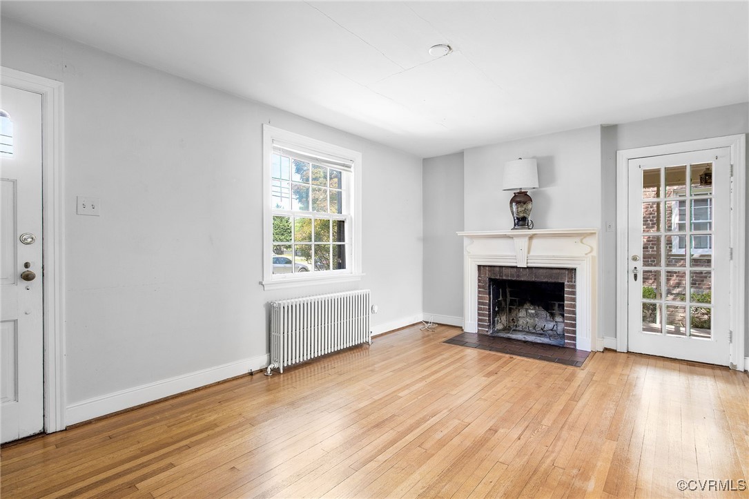 4521 Brook Road Richmond, VA 23227 - Photo 4 of 29 an empty room with wooden floor fireplace and windows