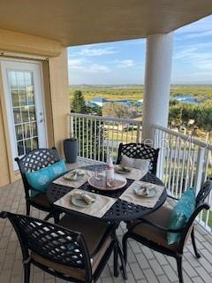 4650 Links Village Drive, Unit B503 Ponce Inlet, FL 32127 - Photo 19 of 47 a view of a dining room with furniture large windows and wooden floor