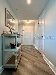 4650 Links Village Drive, Unit B503 Ponce Inlet, FL 32127 - Photo 2 of 47 a bedroom with a bed and a chandelier