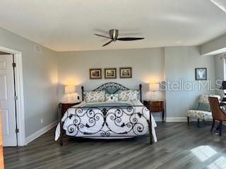 4650 Links Village Drive, Unit B503 Ponce Inlet, FL 32127 - Photo 21 of 47 a bedroom with a bed and wooden floor