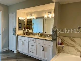 4650 Links Village Drive, Unit B503 Ponce Inlet, FL 32127 - Photo 24 of 47 a bathroom with a granite countertop sink and a mirror