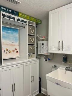 4650 Links Village Drive, Unit B503 Ponce Inlet, FL 32127 - Photo 32 of 47 a utility room with stainless steel appliances a sink and a refrigerator