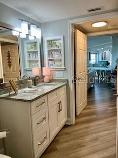 4650 Links Village Drive, Unit B503 Ponce Inlet, FL 32127 - Photo 35 of 47 a bathroom with sinks granite countertop a sink and a wooden floor