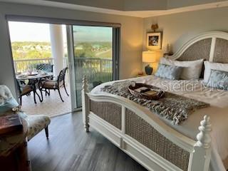 4650 Links Village Drive, Unit B503 Ponce Inlet, FL 32127 - Photo 37 of 47 a bedroom with furniture and a large window