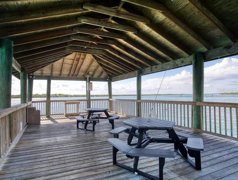 4650 Links Village Drive, Unit B503 Ponce Inlet, FL 32127 - Photo 42 of 47 a roof deck with a table and chairs