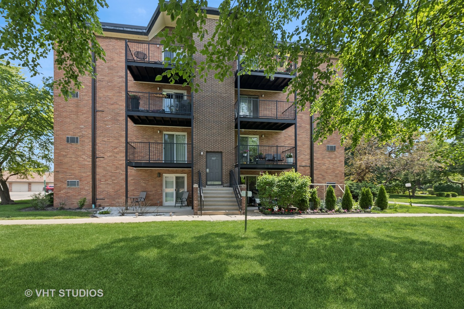 1107 South Old Wilke Road, Unit 205 Rolling Meadows, IL 60008 - Photo 13 of 19 a view of a house with a yard