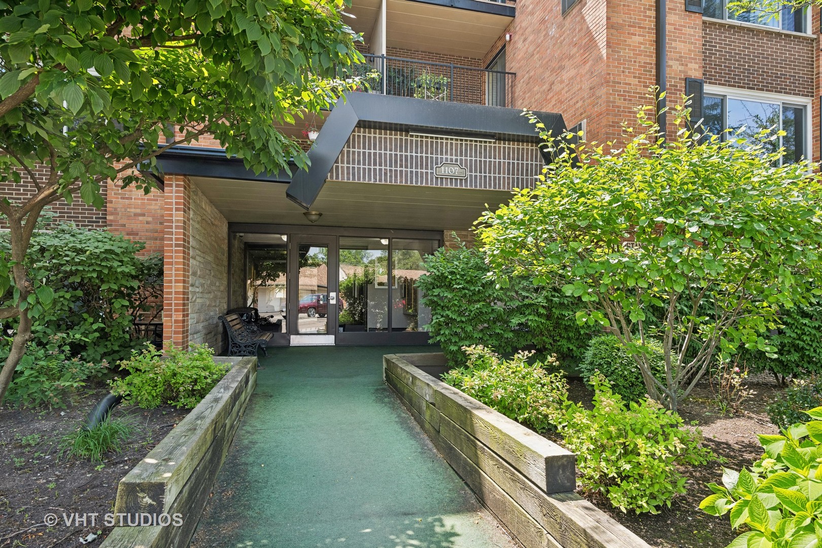 1107 South Old Wilke Road, Unit 205 Rolling Meadows, IL 60008 - Photo 2 of 19 a view of a patio with table and chairs and potted plants