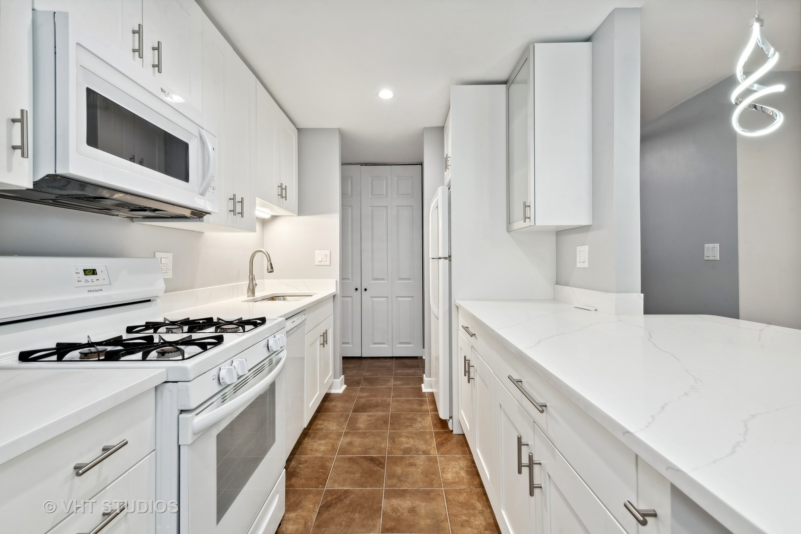 1107 South Old Wilke Road, Unit 205 Rolling Meadows, IL 60008 - Photo 4 of 19 a large kitchen with stainless steel appliances a stove a sink and a refrigerator